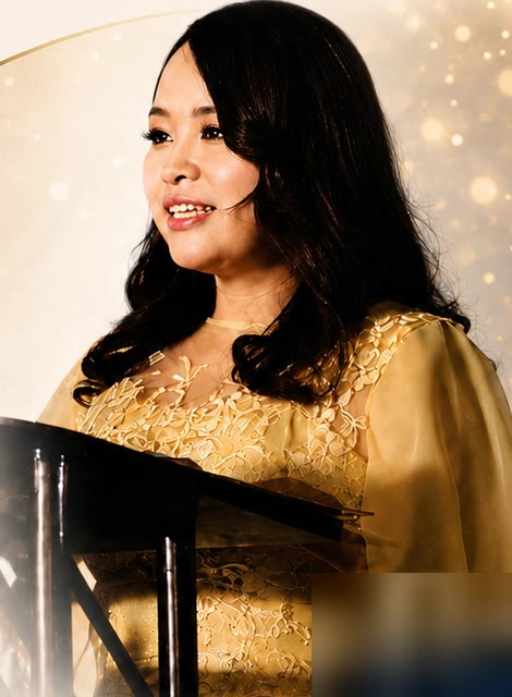 Kimly Hoang-Nakata speaking at a podium today